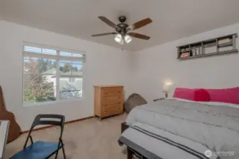 Bedroom #2 offers great natural light a large window, a ceiling fan for added comfort, a walk-in closet, and stylish blinds for both privacy and light control.