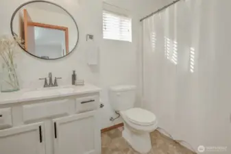 This full bathroom on the second floor is conveniently located near both bedrooms and just off the bonus area. Light and bright, it showcases a stylish vanity topped with a round mirror for a modern touch.