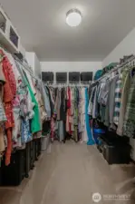 The oversized walk-in closet in the primary bedroom offers ample storage with plenty of hanging space and a full-length shelf above—perfect for keeping everything organized and within reach.