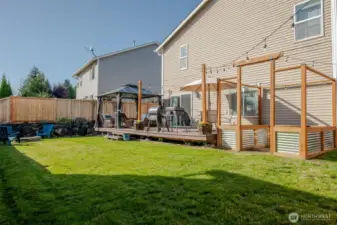 The spacious deck sits right beside beautifully crafted raised garden beds—perfect for enjoying your morning coffee while overlooking your own garden oasis.