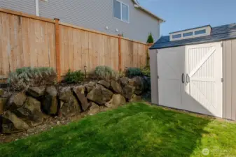 Tucked into the corner of the yard, the spacious shed provides ample storage for lawn equipment, gardening tools, seasonal decorations, outdoor furniture, and more—keeping your backyard organized and clutter-free.