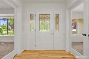 Welcoming Entryway with Leaded Privacy Glass, Refreshed Gleaming Hardwoods, Privacy Glass Double Doors and Statement Lighting