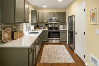 Kitchen with new countertops, back splash, and appliances
