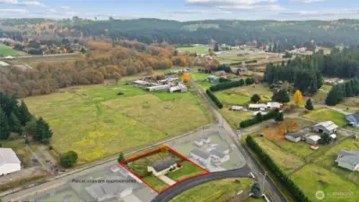 Aerial with subject property highlighted in foreground.  parcel lines approximate.