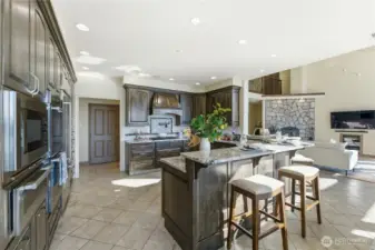 Well-appointed kitchen with multiple ovens, main dishwasher, and a 6-burner gas range complete with RO pot filler
