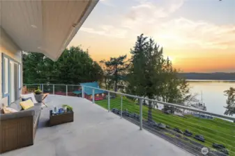 This sun-filled south deck surveys the tranquil bay, the secure deep-water dock, the never-ending views and the two guest cottages tucked to the right