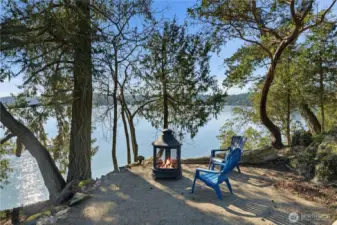 Waterfront relaxation with two firepit/entertainment areas: this one tucked into the trees offering shade
