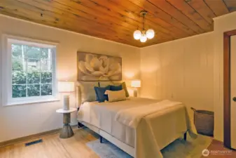 Oak hardwood floors and garden views from main floor bedroom