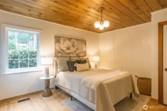 Oak hardwood floors and garden views from main floor bedroom