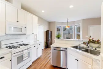 Very efficient & functional eat-in kitchen, with doors to both the garage on left and back yard on the right.