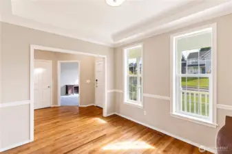Formal dining room looking toward front door and den/office.