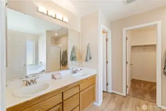 Primary bathroom has double sinks, separate room for toilet, walk-in closet, separate shower and soaking tub.
