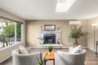 Big window and skylight flood the living room with natural light.