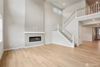 Modern electric fireplace feature wall is focal point of the open plan living area.
