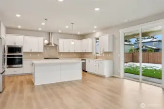 Kitchen opens out to landscaped and fenced back yard. Outdoor sprinkler systems front and back included!