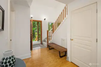 A pretty staircase with abundant windows leads to the second story
