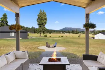 Covered patio providing a great exterior space for entertaining.  Views of the surrounding mountains can be enjoyed while relaxing around the propane fireplace.