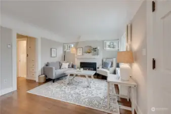 Living room is out of a magazine and includes a convenient gas fireplace, and notice the original built-ins in the hallway.