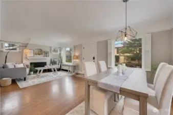 Dining to living room with adorable white shutters adorning the first floor windows.