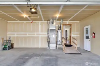 Large oversized garage is accessed from the alley & includes extra space for equipment, freezer, etc. Note the ramp if needed for accessibility.