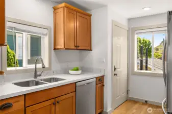 Quartz countertops and stainless steel appliances.Door leads to the deck with the hot tub.
