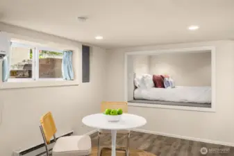 Dining room with a lofted bed area and closet nook.