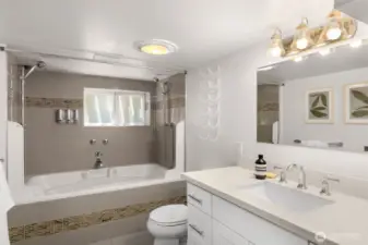 Full bath complete with quartz countertops and a jetted tub.