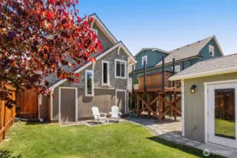 Newly landscaped fenced-in backyard. The door to the left leads to the additional storage and the door to the right leads to the ADU/Lower level.