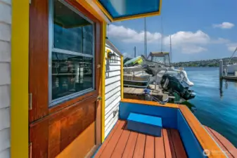 The aft deck’s colorful trim and seating invite you to pause and take in Lake Union, with sailboats and skyline creating a daily backdrop.