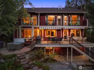 Expansive multi-level outdoor living with elevated decks, hot tub, and covered patio—perfectly designed for entertaining and enjoying this private riverfront retreat.