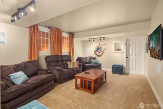 Comfortable media room with ample seating and soft finishes—ideal for movie nights, game days, or relaxed indoor entertaining.