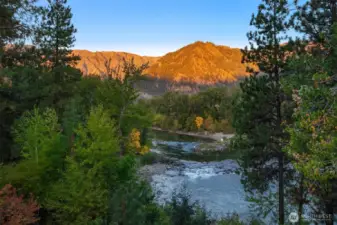 Wake up to breathtaking alpenglow as the surrounding mountains light up above the Wenatchee River, creating a truly unforgettable morning view.