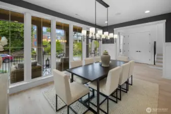 Dining space is framed by expansive windows and natural light, creating an inviting setting for both everyday meals and elevated entertaining.