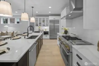 Another angle highlights the kitchen’s refined functionality, with expansive counters, a professional-style cooking area, and a layout designed for both daily use and elevated entertaining.