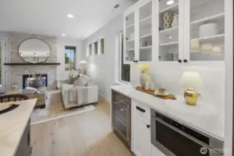 Built-in cabinetry and beverage storage add polish and practicality, creating a sophisticated extension of the kitchen and gathering spaces.