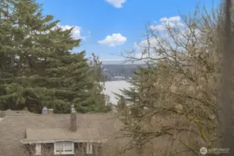 Filtered lake views create a beautiful backdrop, adding a quiet sense of retreat to the upper level.