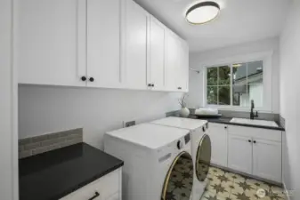 Spacious laundry room with abundant cabinetry, folding space, and a window that brings light into even the most practical corner of the home.