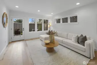 The lower-level living area offers a bright, welcoming retreat with direct access outside, creating flexible space for relaxing, hosting, or extended stays.