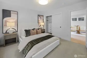 A second view of the lower-level bedroom highlights its clean design, generous proportions, and easy connection to the surrounding guest spaces.