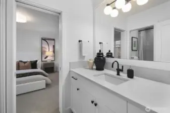 The adjacent lower-level bath is finished with a dual vanity and crisp, timeless details, creating a polished extension of the guest quarters.