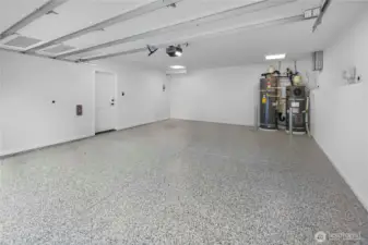 The attached two-car garage offers substantial room for parking, storage, and everyday practicality, with EV-ready capability adding modern convenience.