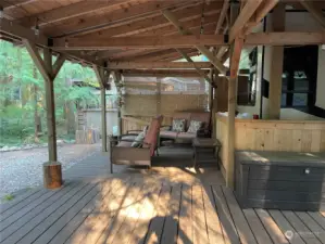 Large, covered deck in back looking at greenbelt.