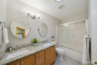 The updated main hall bath features sleek finishes and contemporary design for a refreshing experience.