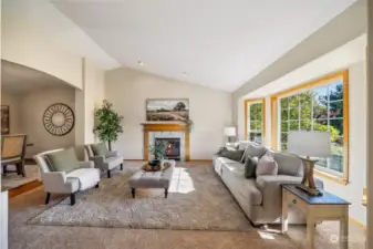 Large windows and a high lofty ceiling add to the spacious feel of the formal living room. Flooring has been updated throughout the residence.