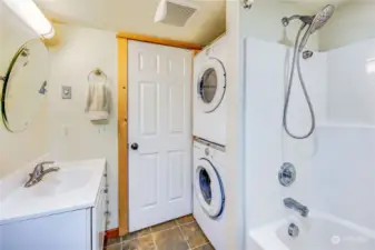 Behind the bathroom door is the stack washer and dryer