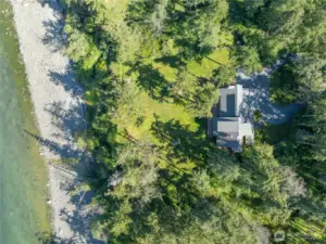Looking directly down at the house , yard and beach.