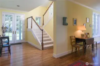 Spacious front entry with French doors and hardwood floors.