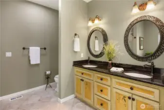 Dual sinks with custom painted cabinets and granite counters.