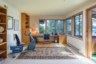Lower level office with built-in book shelves and desk.