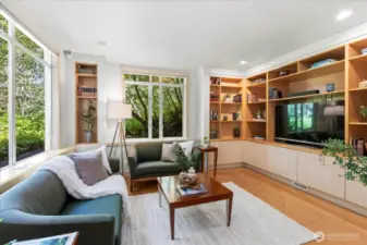 Living room with extensive built-in shelving & storage
